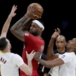  Miami Heat forward LeBron James, middle, is double-teamed by Los Angeles Lakers' Jordan Farmar, left, and Nick Young during the first half of an NBA basketball game in Los Angeles, Wednesday, Dec. 25, 2013. (AP Photo/Chris Carlson)