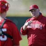 Los Angeles Angels manager Mike Scioscia talks to Joe Blanton during a spring training baseball workout Tuesday, Feb. 12, 2013, in Tempe, Ariz. (AP Photo/Morry Gash)