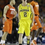 Michigan's Spike Albrecht (2) reacts to play against Syracuse during the first half of the NCAA Final Four tournament college basketball semifinal game Saturday, April 6, 2013, in Atlanta. (AP Photo/Charlie Neibergall)
