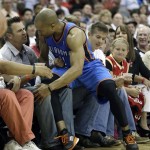 Oklahoma City Thunder's Derek Fisher lands in the lap of fans while chasing a loose ball against the Houston Rockets during the fourth quarter of Game 3 in a first-round NBA basketball playoff series Saturday, April 27, 2013, in Houston. The Thunder beat the Rockets 104-101. (AP Photo/David J. Phillip)