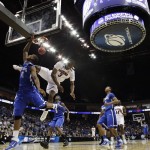 Arizona guard Kevin Parrom tumbles to the ground trying to block a shot by Memphis forward Wesley Witherspoon in the first half of a West Regional NCAA tournament second round college basketball game, Friday, March 18, 2011 in Tulsa, Okla. (AP Photo/Charlie Riedel)