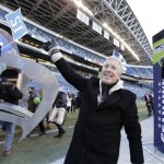 Seattle Seahawks head coach Pete Carroll waves to fans as he leaves CenturyLink Field after a rally at for NFL football's Super Bowl XLVIII champions in Seattle, Wednesday, Feb. 5, 2014. The Seahawks defeated the Denver Broncos on Sunday. (AP Photo/John Froschauer)