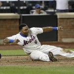 New York Mets' Marlon Byrd reacts after sliding home safe to tie the game during the ninth inning of the baseball game against the Arizona Diamondbacks at Citi Field, Monday, July 1, 2013, in New York. (AP Photo/Seth Wenig)