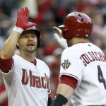 Arizona Diamondbacks' Cody Ross, left, gives teammate Paul Goldschmidt a high-five after Goldschmidt's home run against the Atlanta Braves during the first inning of a baseball game, on Monday, May 13, 2013, in Phoenix. (AP Photo/Ross D. Franklin)