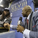 Deion Sanders shakes hands with Seattle Seahawks' Richard Sherman during media day for the NFL Super Bowl XLVIII football game Tuesday, Jan. 28, 2014, in Newark, N.J. (AP Photo/Jeff Roberson)