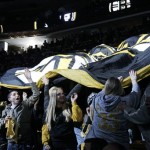 Fans pass a large Boston Bruins banner around the arena before Game 1 of an NHL hockey Stanley Cup first-round playoff series between the Bruins and the Washington Capitals in Boston, Thursday, April 12, 2012. (AP Photo/Elise Amendola)