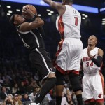 Brooklyn Nets' Paul Pierce (34) is fouled by Miami Heat's Chris Bosh (1) during the second half of an NBA basketball game on Friday, Jan. 10, 2014, in New York. The Nets won the game 104-95. (AP Photo/Frank Franklin II)