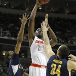 Syracuse forward Rakeem Christmas (25) drives to the basket against California guard Tyrone Wallace (3) and forward Robert Thurman (34) during the first half of a third-round game in the NCAA college basketball tournament Saturday, March 23, 2013, in San Jose, Calif. (AP Photo/Tony Avelar)
