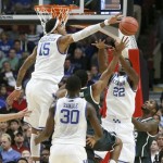 Kentucky forward Willie Cauley-Stein (15) blocks the shot of Michigan State guard Gary Harris as forwards Julius Randle (30) and Alex Poythress also defend during the first half of an NCAA college basketball game Tuesday, Nov. 12, 2013, in Chicago. (AP Photo/Charles Rex Arbogast)