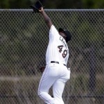 Miami Marlins starting pitcher Arquimedes Caminero catches a fly ball during batting practice at a spring training baseball workout, Friday, Feb. 22, 2013, in Jupiter, Fla. (AP Photo/Julio Cortez)