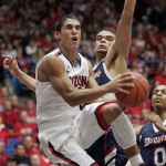 Arizona's Nick Johnson (13) maneuvers against Duquesne's Kadeem Pantophlet, rear, for a shot under the basket during the first half of an NCAA college basketball game at the McKale Center, Wednesday, Nov. 9, 2011, in Tucson, Ariz. (AP Photo/John Miller)