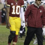 Washington Redskins quarterback Robert Griffin III walks off the field after twisting his knee during the second half of an NFL wild card playoff football game against the Seattle Seahawks in Landover, Md., Sunday, Jan. 6, 2013. (AP Photo/Evan Vucci)
