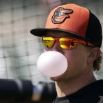  Baltimore Orioles left fielder Nate McLouth blows a bubble as he waits to hit in the batting cage before a baseball spring training exhibition game against the Toronto Blue Jays, Thursday, March 7, 2013, in Sarasota, Fla. (AP Photo/Charlie Neibergall)