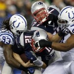 New England Patriots quarterback Tom Brady (12) is sacked by Indianapolis Colts linebacker Erik Walden (93) and defensive tackle Jeris Pendleton (61) during the first half of an AFC divisional NFL playoff football game in Foxborough, Mass., Saturday, Jan. 11, 2014. (AP Photo/Michael Dwyer)