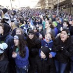 Seattle Seahawks fans line the streets at a parade for NFL football's Super Bowl XLVIII champions on Wednesday, Feb. 5, 2014, in Seattle. The Seahawks defeated the Denver Broncos on Sunday. (AP Photo/Elaine Thompson)