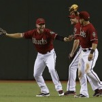Arizona Diamondbacks' Cody Ross, left, celebrates the final out against the Miami Marlins with teammates A.J. Pollock, and Gerardo Parra, right, in the ninth inning of a baseball game on Wednesday, June 19, 2013, in Phoenix. The Diamondbacks defeated the Marlins 3-1. (AP Photo/Ross D. Franklin)
