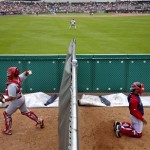 St. Louis Cardinals catcher Jesus Montero, left, and Boston Red Sox bullpen catcher Manny Martinez, right, warm up their respective pitchers in the seventh inning of an exhibition spring training baseball game, Tuesday, Feb. 26, 2013, in Fort Myers, Fla. (AP Photo/David Goldman)