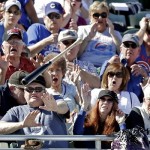  Fans try to get out of the way after Chicago Cubs' Christian Villanueva lost his bat during the fifth inning of an exhibition spring training baseball game against the Colorado Rockies, Tuesday, Feb. 26, 2013, in Phoenix. (AP Photo/Morry Gash)