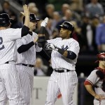New York Yankees' Lyle Overbay, left, and Chris Stewart greet Robinson Cano at the plate after they scored on Cano's fourth-inning, three-run home run in a baseball game at Yankee Stadium in New York, Tuesday, April 16, 2013. Arizona Diamondbacks catcher Miguel Montero is at far right. (AP Photo/Kathy Willens)