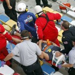 An injured spectators are treated after a crash at the conclusion of the NASCAR Nationwide Series auto race Saturday, Feb. 23, 2013, at Daytona International Speedway in Daytona Beach, Fla. Driver Kyle Larson's car hit the safety fence sending car parts and other debris flying into the stands. (AP Photo/David Graham)
