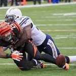  Cincinnati Bengals running back Giovani Bernard (25) fumbles as he is hit by San Diego Chargers linebacker Donald Butler in the first half of an NFL wild-card playoff football game on Sunday, Jan. 5, 2014, in Cincinnati. (AP Photo/Tom Uhlman)
