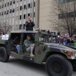 Baltimore Ravens head coach John Harbaugh applauds fans while riding in a Humvee during the Ravens victory parade Tuesday, Feb. 5, 2013, in Baltimore. The Ravens defeated the San Francisco 49ers in NFL football's Super Bowl XLVII 34-31 on Sunday. (AP Photo/Gail Burton)