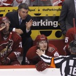 Phoenix Coyotes head coach Dave Tippett, top, 
leans over players Eric Belanger, left, and 
Mikkel Boedker (89), of Denmark, to argue with 
referee Greg Kimmerly (18) during the second 
period in Game 4 of a first-round NHL hockey 
Stanley Cup playoffs series Wednesday, April 
20, 2011, in Glendale, Ariz. (AP Photo/Ross D. 
Franklin)