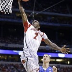 Louisville guard Russ Smith (2) goes up with a layup past Duke's Mason Plumlee (5) during the first half of the Midwest Regional final in the NCAA college basketball tournament, Sunday, March 31, 2013, in Indianapolis. (AP Photo/Michael Conroy)