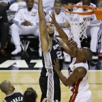 San Antonio Spurs forward Tim Duncan (21) shoots against Miami Heat center Chris Bosh (1) during the first half of Game 6 of the NBA Finals basketball series, Tuesday, June 18, 2013 in Miami. (AP Photo/Wilfredo Lee)