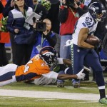Denver Broncos cornerback Champ Bailey (24) reaches for Seattle Seahawks wide receiver Doug Baldwin (89) during the first half of the NFL Super Bowl XLVIII football game Sunday, Feb. 2, 2014, in East Rutherford, N.J. (AP Photo/Matt York)
