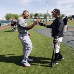 Texas Rangers' Adrian Beltre, left, shakes hands with San Francisco Giants' Marco Scutaro during batting practice before an exhibition spring training baseball game on Friday, March 15, 2013 in Scottsdale, Ariz. (AP Photo/Marcio Jose Sanchez)
