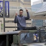 Baltimore Ravens quarterback and Super Bowl MVP Joe Flacco gestures while riding in a Humvee during the Ravens victory parade Tuesday, Feb. 5, 2013, in Baltimore. The Ravens defeated the San Francisco 49ers in NFL football's Super Bowl XLVII 34-31 on Sunday. (AP Photo/Gail Burton)