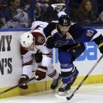 Phoenix Coyotes' Shane Doan, left, is checked into the boards by St. Louis Blues' Alex Pietrangelo during the third period of an NHL hockey game Tuesday, Jan. 14, 2014, in St. Louis. The Blues won 2-1. (AP Photo/Jeff Roberson)