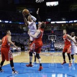 Oklahoma City Thunder guard Russell Westbrook (0) shoots over Houston Rockets center Omer Asik (3) in the first quarter of Game 2 of their first-round NBA basketball playoff series in Oklahoma City, Wednesday, April 24, 2013. (AP Photo/Sue Ogrocki)