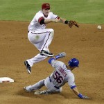New York Mets' Andres Torres (56) is forced out as Arizona Diamondbacks' Stephen Drew turns a double play on the Mets' Rob Johnson during the sixth inning of a baseball game on Thursday, July 26, 2012, in Phoenix. (AP Photo/Matt York)