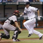 Tampa Bay Rays' Matt Joyce scores past Arizona Diamondbacks catcher Wil Nieves on a sixth-inning sacrifice fly by the Rays' Yunel Escobar off pitcher Will Harris during an interleague baseball game Tuesday, July 30, 2013, in St. Petersburg, Fla. (AP Photo/Chris O'Meara)