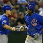 Chicago Cubs' Junior Lake, right, shakes hands with third base coach David Bell after Lake's 2-run home run against the Arizona Diamondbacks in the fifth inning of a baseball game on Monday, July 22, 2013, in Phoenix. (AP Photo/Ross D. Franklin)