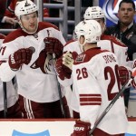  Phoenix Coyotes' Michael Stone (26) is congratulated by his teammates after scoring a goal during the first period of an NHL hockey game against the Chicago Blackhawks in Chicago, Thursday, Nov. 14, 2013. (AP Photo/Nam Y. Huh)