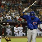 Chicago Cubs' Starlin Castro, right, shows his frustration after striking out as Arizona Diamondbacks' Wil Nieves looks over at Castro in the first inning of a baseball game on Tuesday, July 23, 2013, in Phoenix. (AP Photo/Ross D. Franklin)
