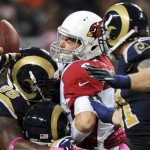 Arizona Cardinals quarterback Kevin Kolb, center, is sacked by St. Louis Rams defensive end Robert Quinn (94) with help from defensive tackle Kendall Langford (98) and defensive end Chris Long, right, during the second quarter of an NFL football game, Thursday, Oct. 4, 2012, in St. Louis. (AP Photo/L.G. Patterson)