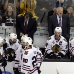 Chicago Blackhawks head coach Joel Quenneville, right, team captain Jonathan Toews (19) and their team pause during a break in pay in the third period in Game 3 of the NHL hockey Stanley Cup Finals against the Boston Bruins in Boston, Monday, June 17, 2013. (AP Photo/Charles Krupa)