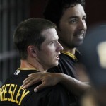 Pittsburgh Pirates' Alex Presley, left, is congratulated by teammates including Rod Barajas, top, after Presley scored a run against the Arizona Diamondbacks during the ninth inning in a baseball game Tuesday, April 17, 2012, in Phoenix. The Pirates defeated the Diamondbacks 5-4.(AP Photo/Ross D. Franklin)