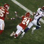 Denver Broncos wide receiver Eric Decker (87) dives to the end zone for a touchdown after making a catch against Kansas City Chiefs cornerback Brandon Flowers (24) and defensive back Quintin Demps (35) during the second half of an NFL football game, Sunday, Dec. 1, 2013, in Kansas City, Mo. (AP Photo/Charlie Riedel)