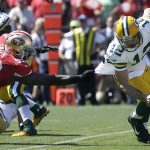 Green Bay Packers quarterback Aaron Rodgers (12) tries to run from San Francisco 49ers linebacker Aldon Smith (99) during the first quarter of an NFL football game, Sunday, Sept. 8, 2013, in San Francisco. Smith sacked Rodgers on the play. (AP Photo/Jeff Chiu)