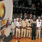  Miami Heat players and coaches watch as the 2013 NBA championship banner is raised before the Heat's season-opener basketball game against the Chicago Bulls on Tuesday, Oct. 29, 2013, in Miami. (AP Photo/Miami Herald, Charles Trainor Jr.) MAGS OUT