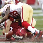 Arizona Cardinals' John Skelton, bottom, fumbles the ball after being hit by San Francisco 49ers' Dashon Goldson, top, during the second quarter in an NFL football game, Sunday, Dec. 11, 2011, in Glendale, Ariz.(AP Photo/Paul Connors)