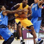 Los Angeles Lakers' Kobe Bryant, center, is defended by Dallas Mavericks' O.J. Mayo, left, and Shawn Marion in the first half of an NBA basketball game in Los Angeles, Tuesday, Oct. 30, 2012. (AP Photo/Jae C. Hong)