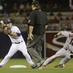 San Diego Padres second baseman Jedd Gyorko relays to first over Arizona Diamondbacks' Willie Bloomquist to complete a double play as umpire Jerry Layne watches in the first inning of a baseball game Tuesday, Sept. 24, 2013, in San Diego. (AP Photo/Lenny Ignelzi)