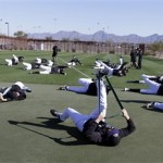 Colorado Rockies pitchers and catchers stretch before a spring training baseball workout Tuesday, Feb. 12, 2013, in Scottsdale, Ariz. (AP Photo/Darron Cummings)