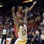  Miami Heat's Chris Bosh is defended by Phoenix Suns' P.J. Tucker (17) during the first half of an NBA basketball game, Monday, Nov. 25, 2013, in Miami. (AP Photo/Lynne Sladky)